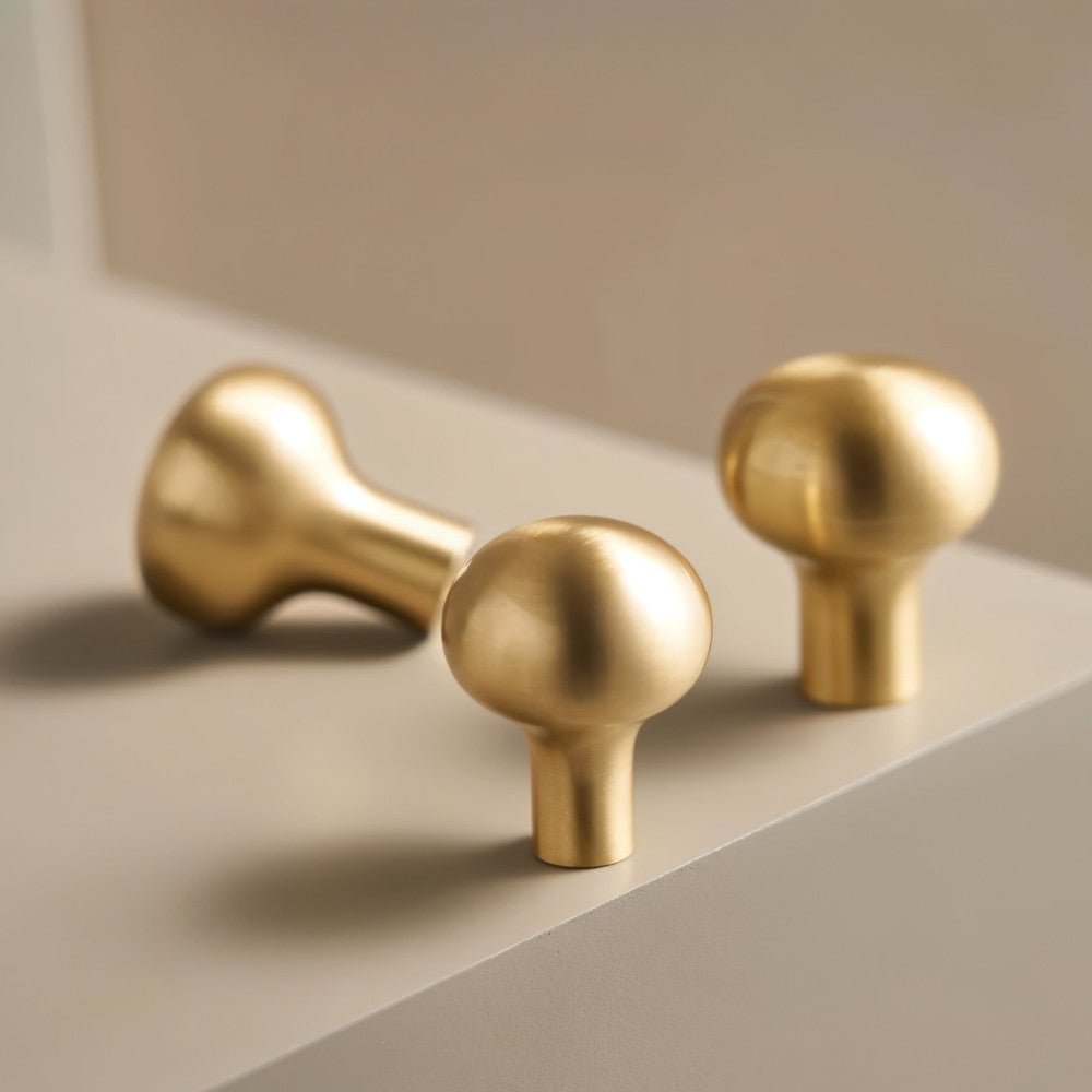 "Modern minimalist brushed brass knobs for contemporary kitchen or bathroom cabinets."