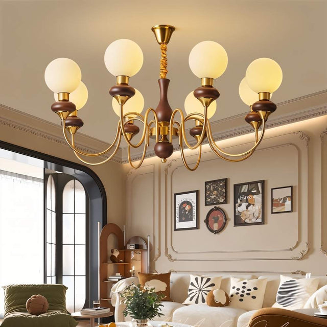 "Gold and dark wood Eurot chandelier with four frosted glass globes hanging in a traditional bedroom."