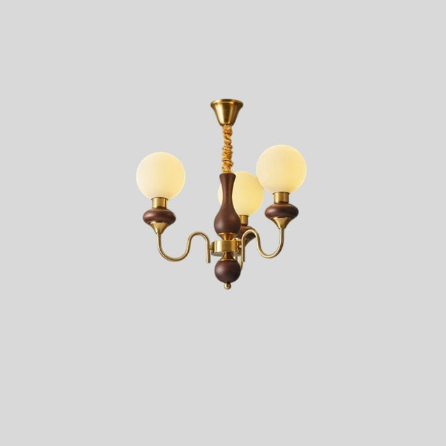"Gold and dark wood Eurot chandelier with four frosted glass globes, isolated on a light gray background."