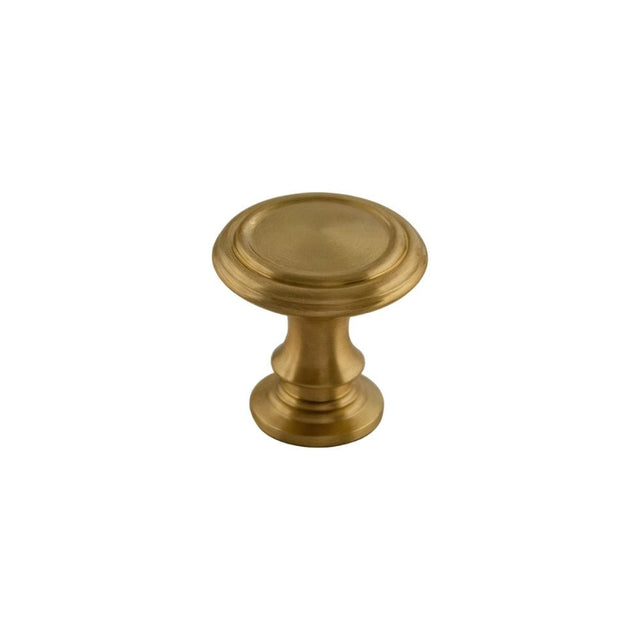 "Round, solid brass cabinet knob with intricate classical details and a golden finish."
