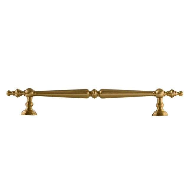 "Ornate brass pull bar handle with a tapered silhouette and intricate classical details."