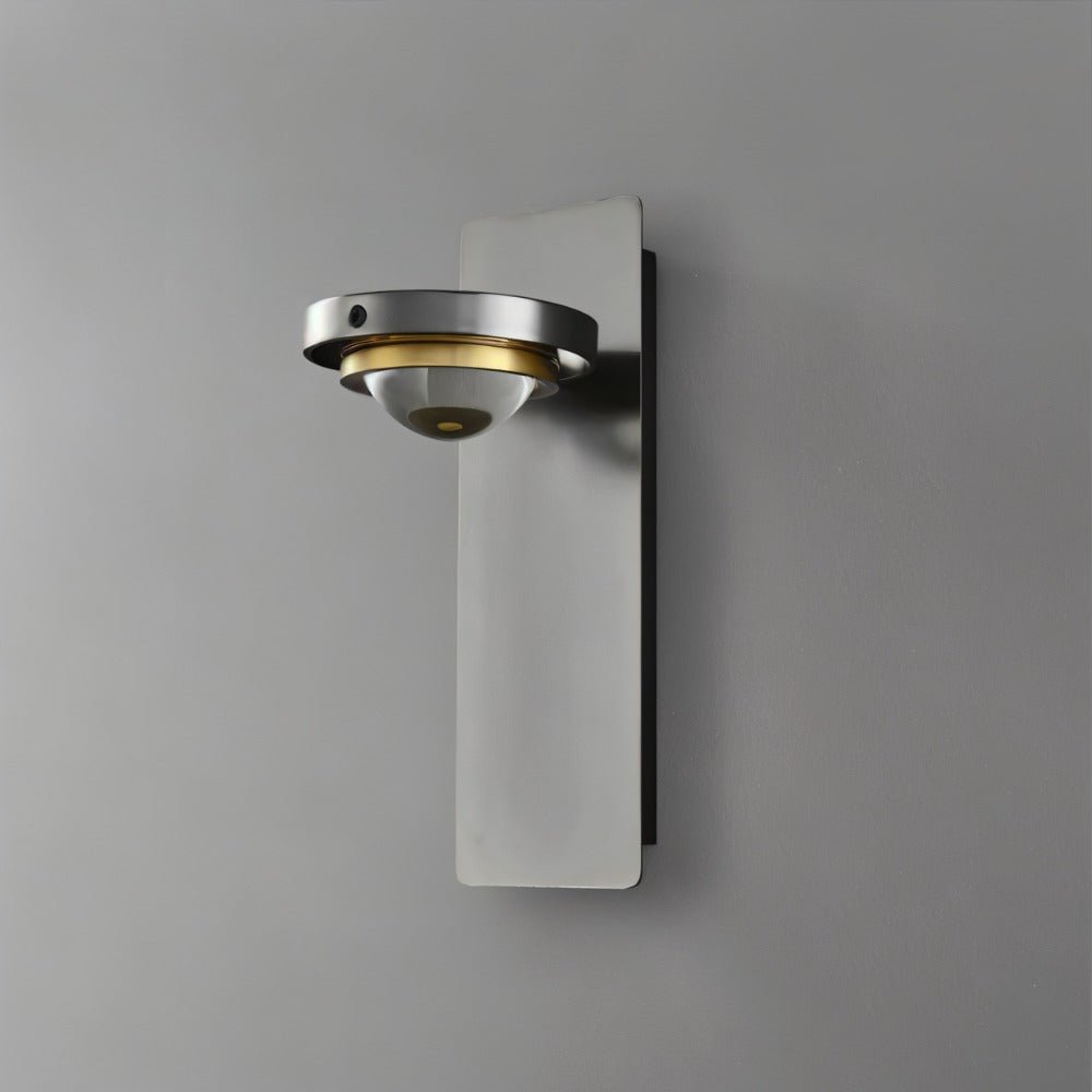 "A modern gunmetal wall lamp with an adjustable light and glass lens, shown against a gray background."