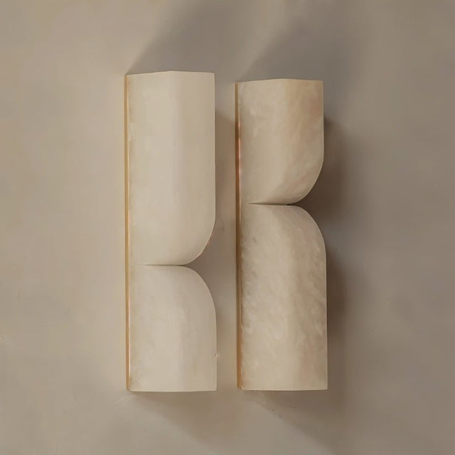 "A pair of double-curved alabaster wall lamps, showcasing a modern design."