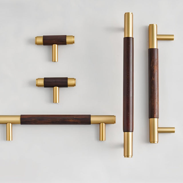 "Set of wood and brass knobs and pull bars with cylindrical design on a white background."