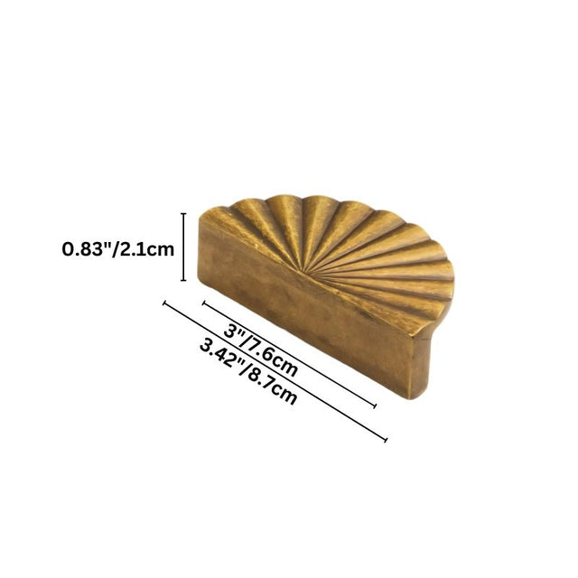 "Dimensions of a vintage brass fan-shaped drawer pull made of durable metal with a ridged, pleated surface and intricate grooves, in a half-moon Art Deco-inspired design: 3 inches center-to-center, 3.42 inches overall length, and 0.83 inches in depth."