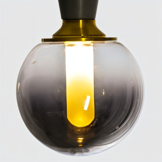 "Close-up of a smoky glass orb pendant light, showcasing its modern design and warm light diffusion."