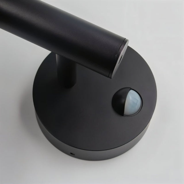 "Close-up of the motion sensor on a sleek, modern outdoor wall lamp."