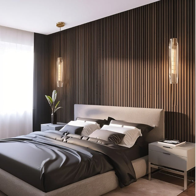 "Pair of elegant pendant lights with elongated, faceted crystal shades and brass frames flanking a modern bed, serving as both pendant lights and wall sconces."