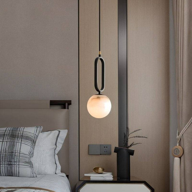 Gong Alabaster Pendant Light - Elegant Design installed beside a bed, adding soft ambient lighting and modern charm to a bedroom setting.