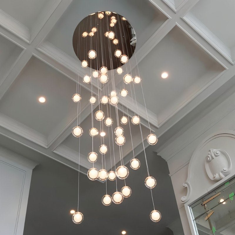 Hanging Height Extension with a polished chrome finish, featuring multiple suspended light globes in a modern interior settin