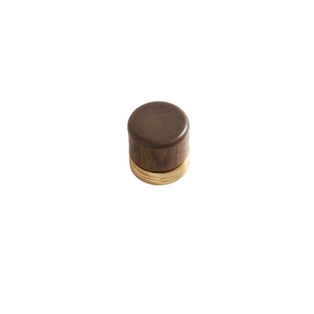 "Close-up of a modern knob featuring a wooden top and a golden metallic base."