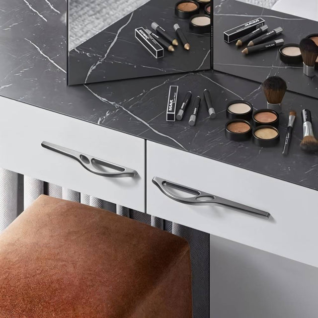 "Sleek, black curved pull bar handles on a modern white wardrobe in a minimalist room."