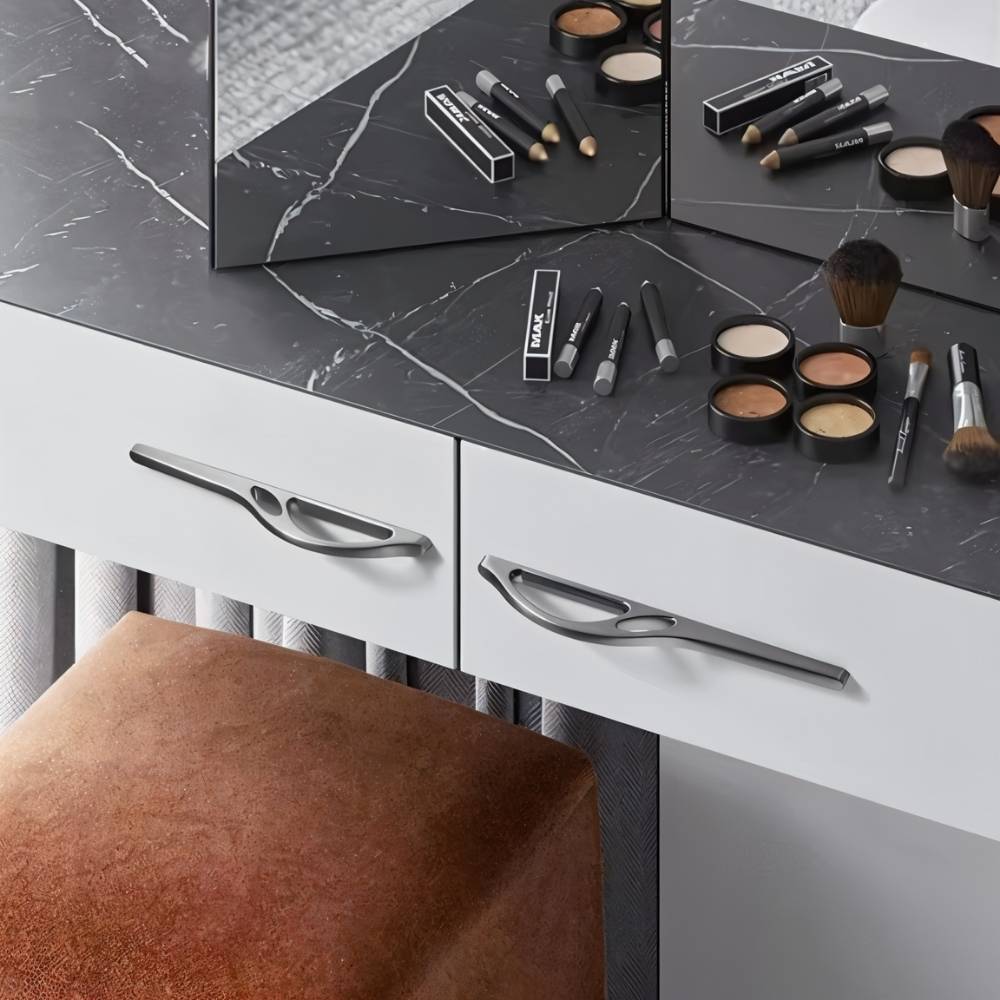"Sleek, black curved pull bar handles on a modern white wardrobe in a minimalist room."