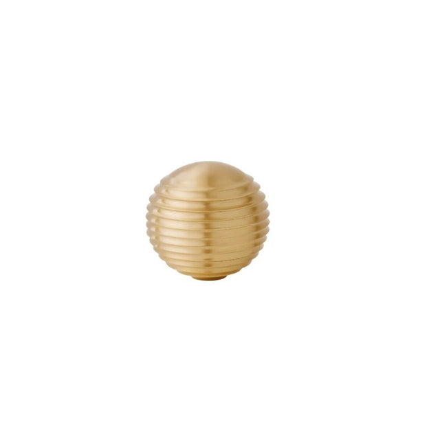 "Gold brass ribbed knob, isolated on a white background."