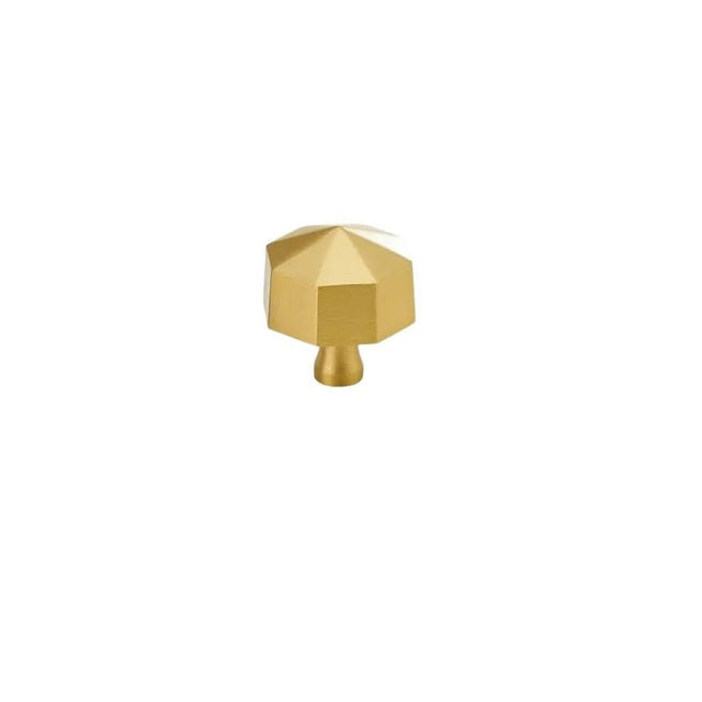 "Angled view of a gold brass hexagonal knob, isolated on a white background."