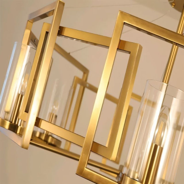 "A close-up view of a modern chandelier with a geometric brass frame and cylindrical glass shades, showcasing the detailed design."
