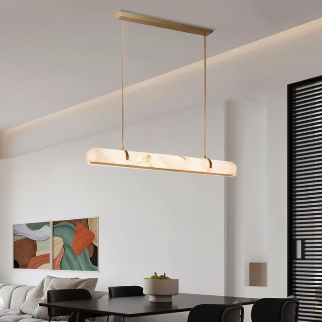 "Modern alabaster and copper linear chandelier providing soft, diffused light in a contemporary living room."