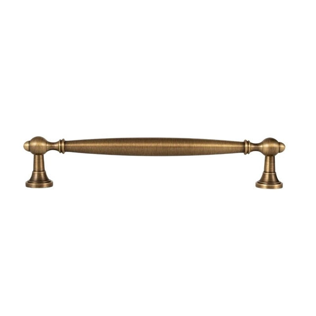 "An antique brass pull bar with a classic, elegant design, isolated on a white background."