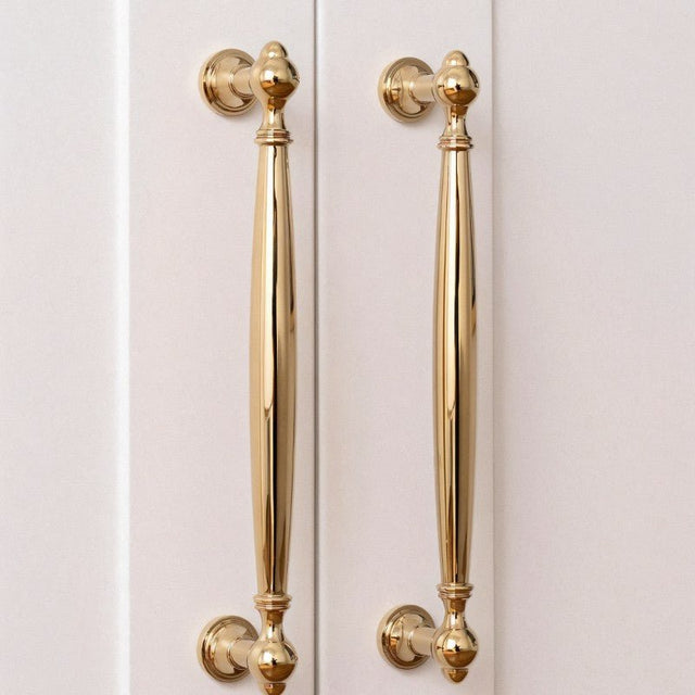 "Polished gold brass pull bars on cabinet doors, showcasing an elegant, timeless design for luxury interiors."