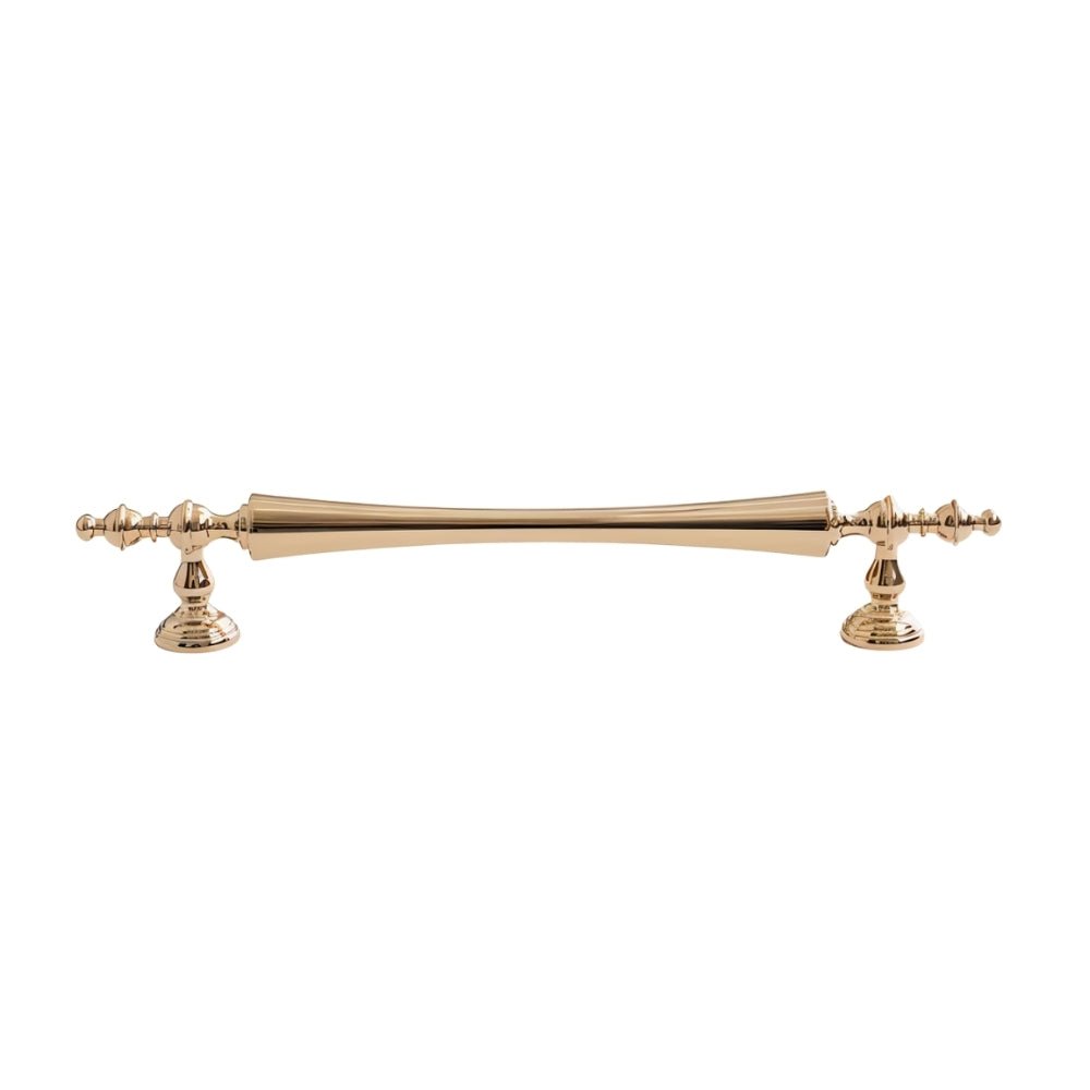 "Brass pull bar handle with a tapered spindle design and intricate finials isolated on a white background."
