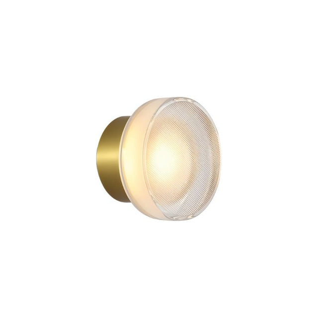 "A modern, minimalist wall lamp with a circular glass diffuser and a sleek brass frame, emitting a warm, radiant glow."