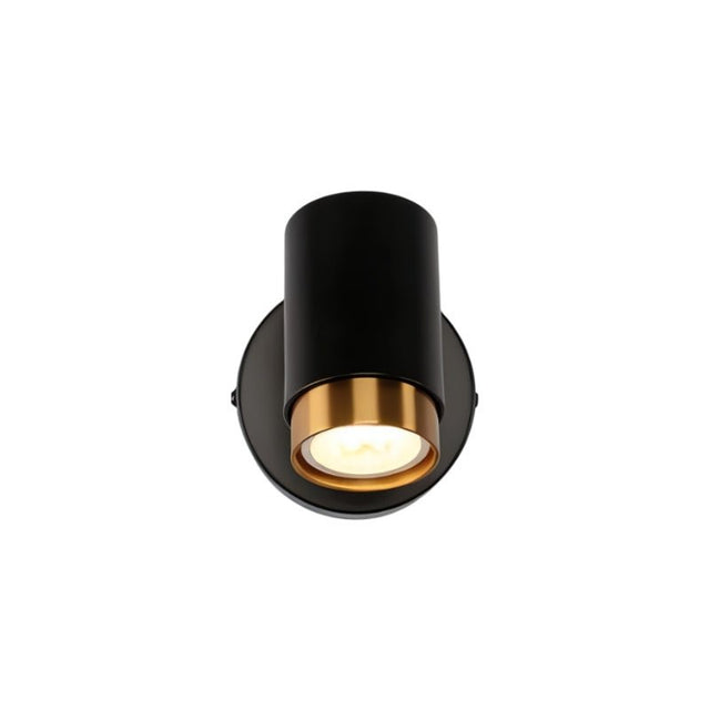 "A black wall lamp with a round base and a cylindrical shade, shown lit up against a white background."