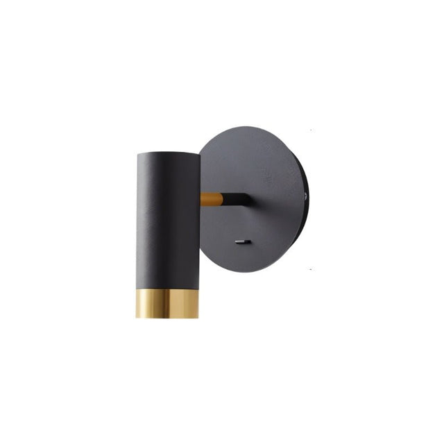 "A black wall lamp with a round base and a cylindrical shade, shown against a white background."