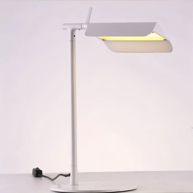 "Modern white table lamp with an adjustable shade, crafted from durable metal for focused lighting in contemporary spaces"
