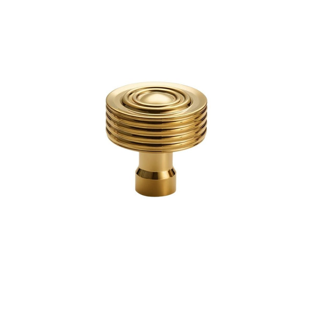 "A brass knob with a concentric ring design and ridged surface, suitable for modern and transitional interiors."