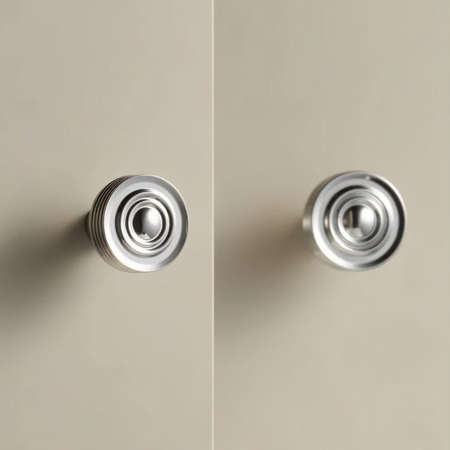 "Pair of nickel-finished brass knobs with a concentric ring design and ridged surface, suitable for cabinets and drawers in modern and transitional spaces."