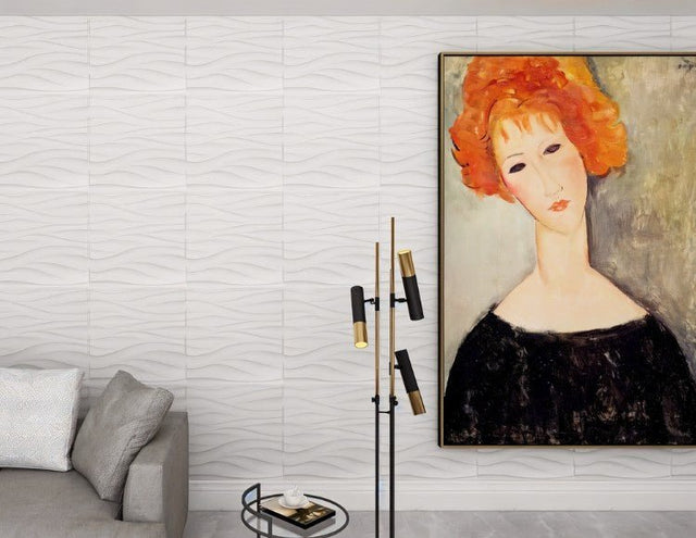 Lavic 3D wavy wall panels in a modern living room with a gray sofa and abstract portrait, creating a sophisticated textured wall.
