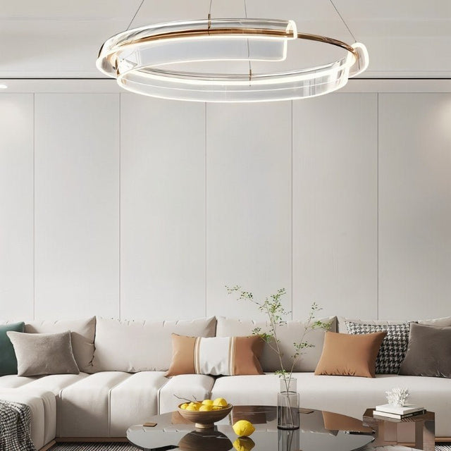 "An asymmetric dual-ring chandelier with acrylic and LED lighting in a living room."