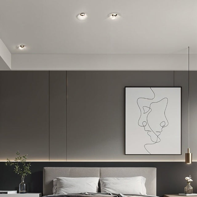 "Bedroom featuring multiple Loux Trimless Downlights in a minimalist design, seamlessly integrated into the ceiling, made from gypsum and aluminum for a modern aesthetic."