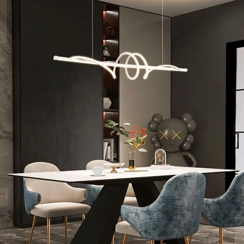"A modern white linear pendant light with wave-like curves, hanging above a dining table in a modern dining room with art."