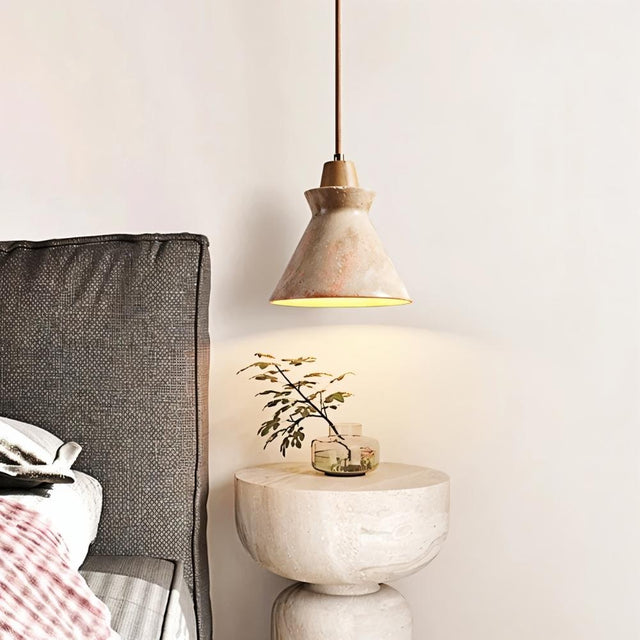 Menra Pendant Light beside a bed, enhancing bedroom ambiance with its natural stone texture and warm lighting effect.