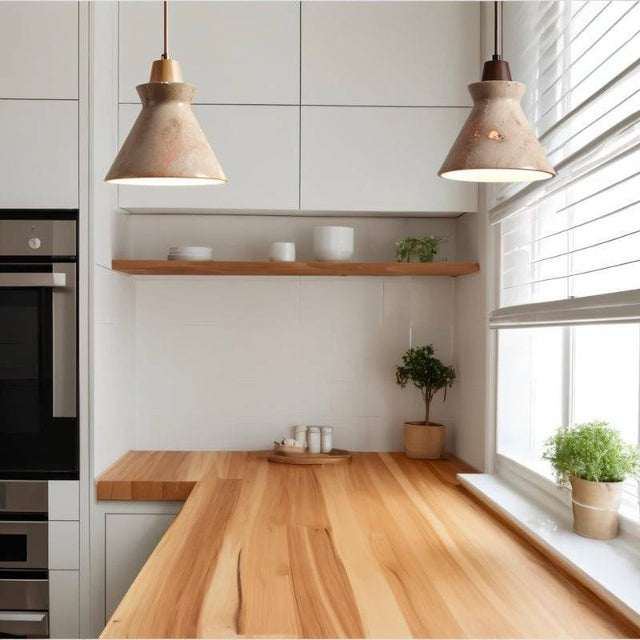 Pair of Menra Pendant Lights above a wooden kitchen counter, blending stone and wood for a minimalist modern kitchen look.