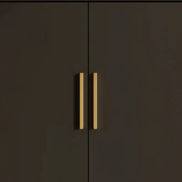 "Pair of sleek geometric brass pull bars on dark modern cabinets."