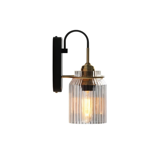 "A brass wall lamp with a ribbed glass shade, isolated on a white background."