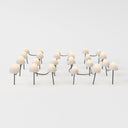 Three groups of cream-colored mushroom-shaped outdoor lamps with dark stems arranged on a white surface.