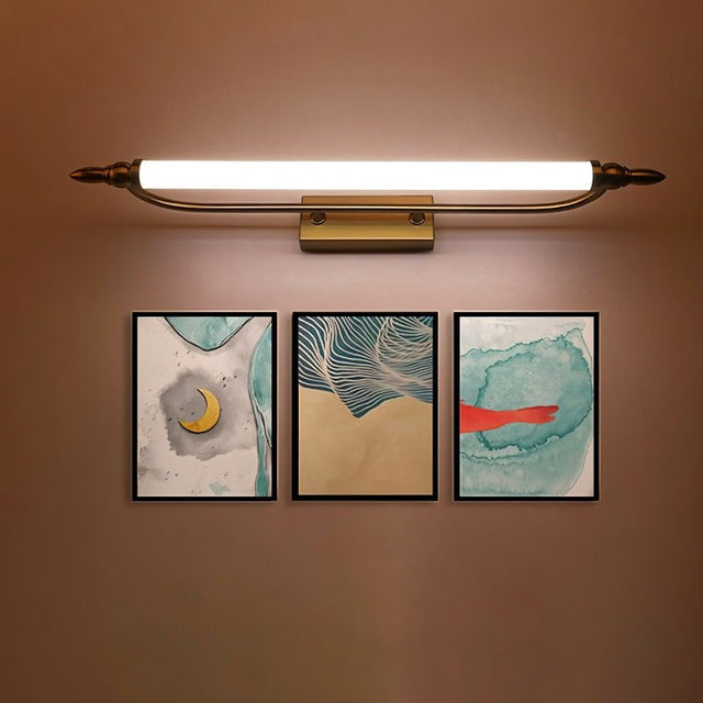 "A vintage-inspired LED wall lamp illuminating three framed artworks on a wall."