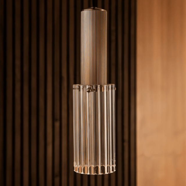 Detailed view of Nayra Copper Glass Pendant Light highlighting its ribbed glass and copper top, ideal for sculptural lighting in living spaces.
