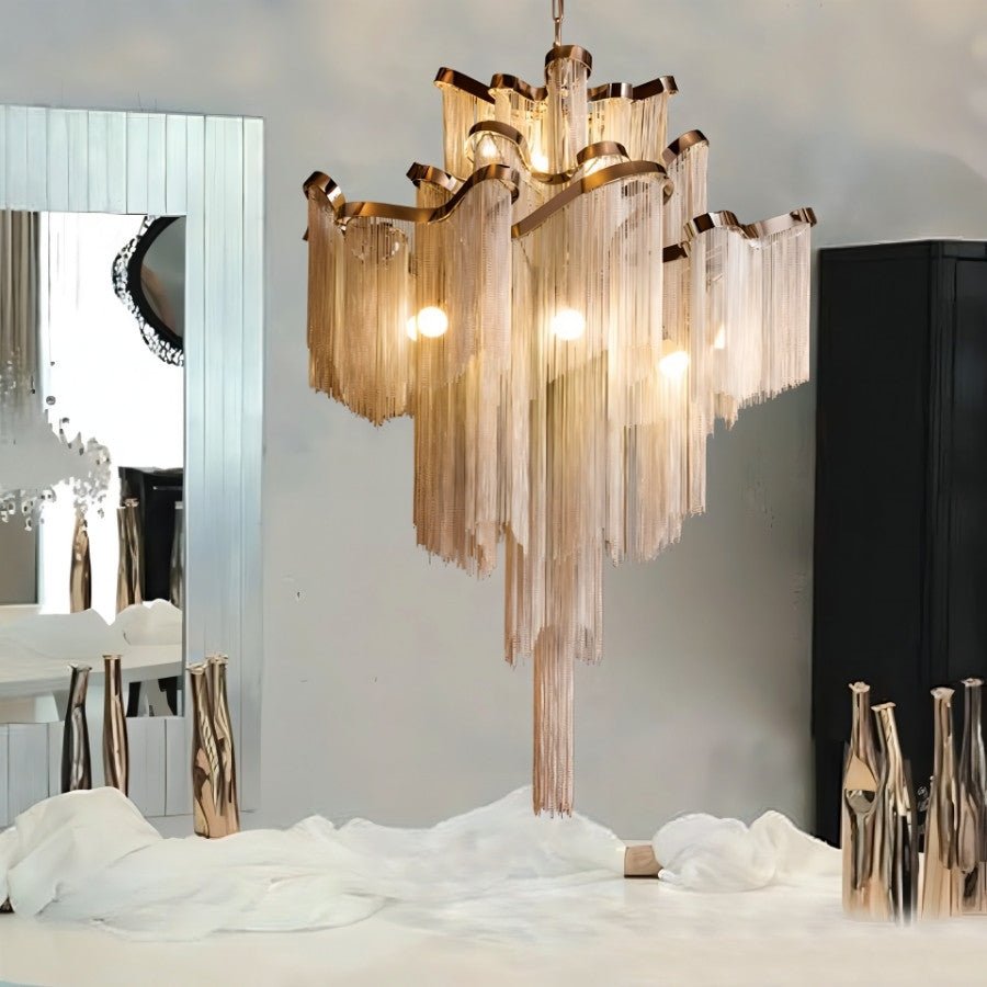 Nazra Chandelier – Open Box gold version displayed above a modern vanity, showcasing its elegant Art Deco-inspired metallic fringe design.
