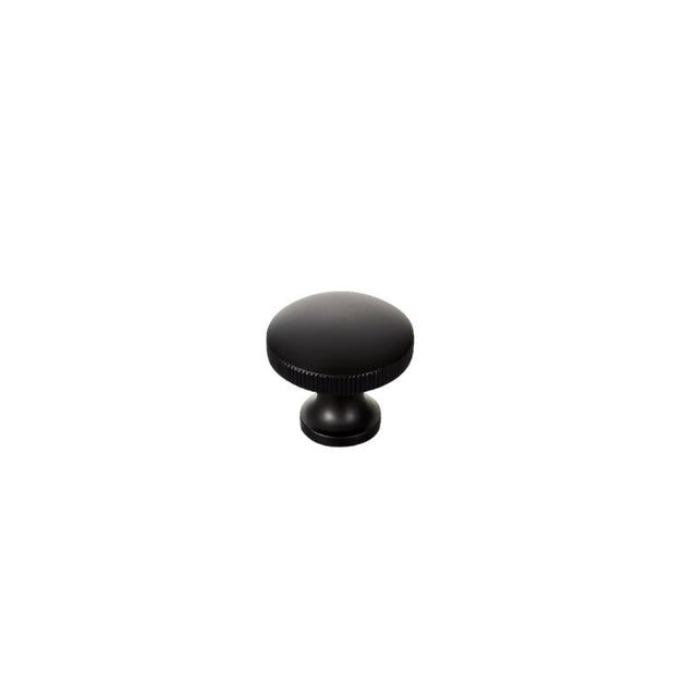 "A minimalist black aluminum cabinet knob with a textured grip."