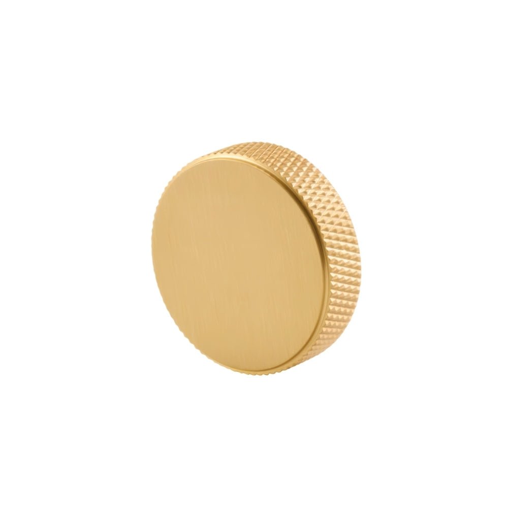 "A gold brass knurled knob shown in a side view."