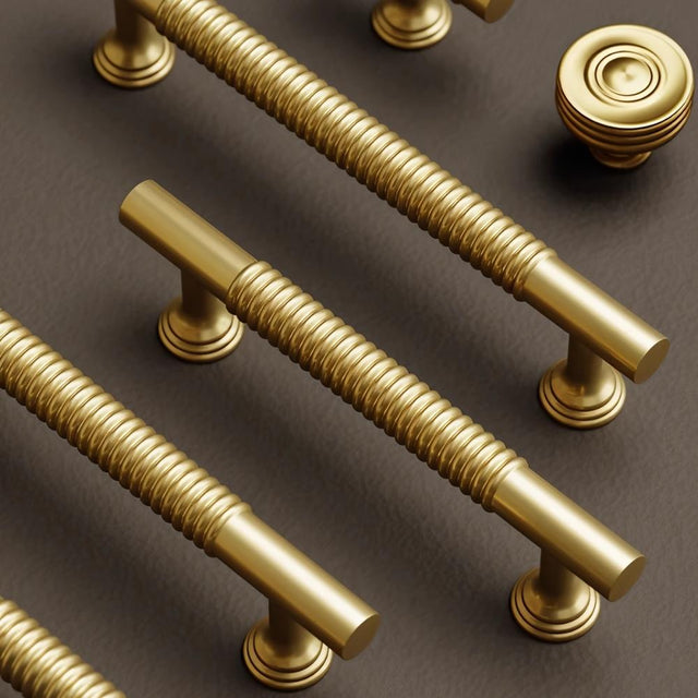 "Set of solid brass knobs and pull bars with a sleek, grooved design, suitable for cabinets, wardrobes, or vanities."