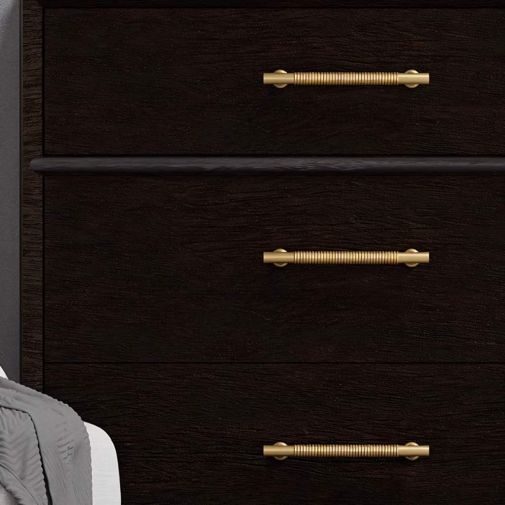 "Solid brass pull bar handles with a grooved design on a dark wood dresser."