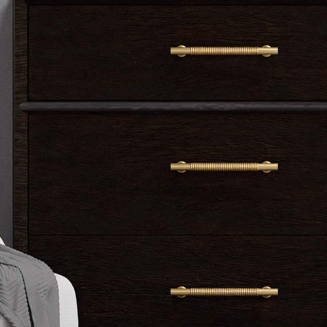 "Solid brass pull bar handles with a grooved design on a dark wood dresser."