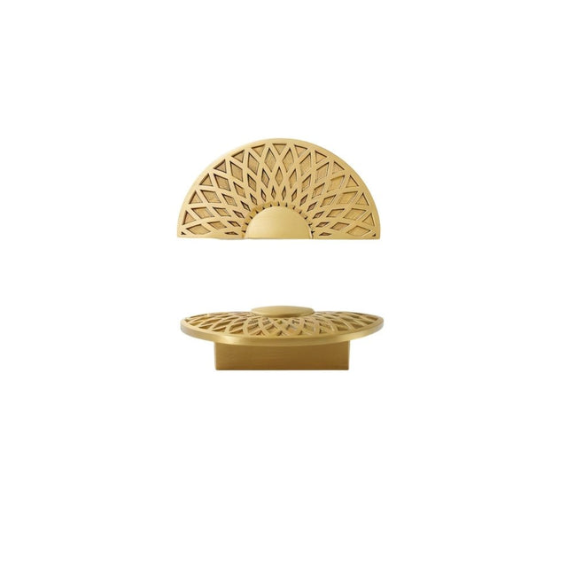 "A gold brass geometric knob with a lattice and sunburst design, isolated on a white background."