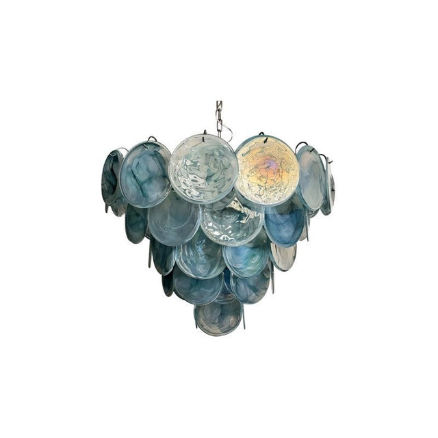 "A modern, round chandelier with cascading blue and iridescent glass discs, suspended by a chain."