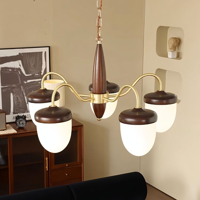 "A 5-light chandelier with brass arms, wooden centerpiece, and frosted glass shades in a living room setting."